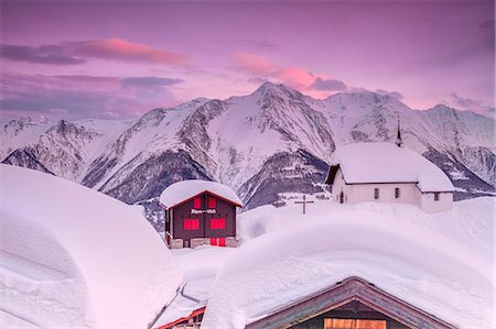 simsearch:841-07081444,k - Pink sky at sunset frames the snowy mountain huts and church, Bettmeralp, district of Raron, canton of Valais, Switzerland, Europe Stock Photo - Rights-Managed, Code: 841-08729468