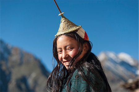 simsearch:841-02947131,k - A Layap girl wearing a traditional hat smiles for the camera in the remote village of Laya, Bhutan, Asia Stock Photo - Rights-Managed, Code: 841-08729552