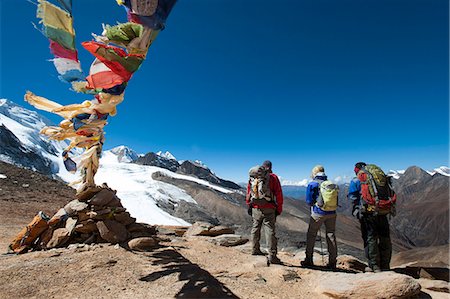 A windy prayer flag strewn cairn marks the top of the Kagmara La, the highest point in the Kagmara Valley at 5115m, Dolpa Region, Himalayas, Nepal, Asia Stock Photo - Rights-Managed, Code: 841-08797854