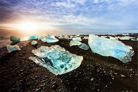 Icebergs on a black sand volcanic beach next to the Jokulsarlon glacial lake in Vatnajokull National Park in southeast Iceland, Polar Regions Stock Photo - Rights-Managed, Code: 841-08860654