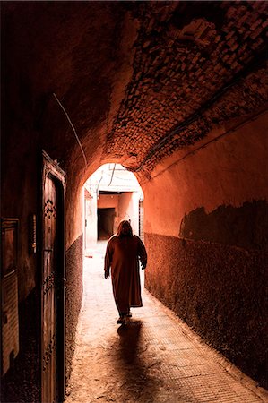 Local man dressed in traditional djellaba walking through archway in a street in the Kasbah, Marrakech, Morocco, North Africa, Africa Stock Photo - Rights-Managed, Code: 841-09077055