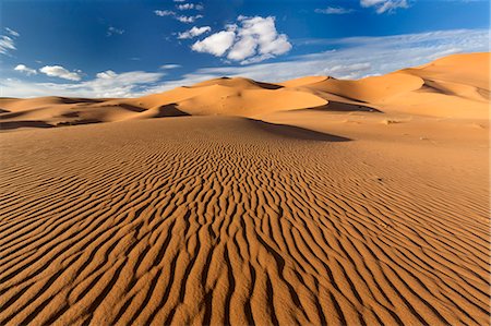 Wide angle view of the ripples and dunes of the Erg Chebbi Sand sea, part of the Sahara Desert near Merzouga, Morocco, North Africa, Africa Stock Photo - Rights-Managed, Code: 841-09077067