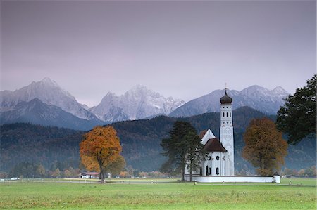 schwangau - Pink sunrise on St. Coloman Church surrounded by woods and mist of autumn, Schwangau, Bavaria, Germany, Europe Stock Photo - Rights-Managed, Code: 841-09085846