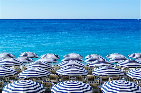 Blue and white beach parasols, Nice, Alpes Maritimes, Cote d'Azur, Provence, France, Mediterranean, Europe Stock Photo - Rights-Managed, Code: 841-09086006