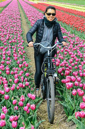 riding crop - Young woman biking through tulip fields near Lisse, Netherlands, Europe Stock Photo - Rights-Managed, Code: 841-09086098