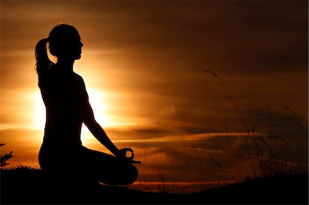 Silhouette of a woman in lotus position, practising yoga against the light of the evening sun, French Alps, France, Europe Stock Photo - Rights-Managed, Code: 841-09108191