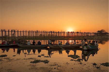 Sunset at U Bein bridge, oldest and longest teak bridge in the world, across Lake Taungthaman, Amarapura, Myanmar (Burma), Asia Stock Photo - Rights-Managed, Code: 841-09163218