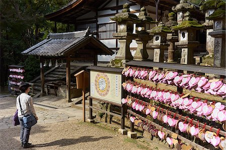 simsearch:841-07083487,k - Stone lanterns and heart-shaped votives wishing good luck to new marriages at Kasuga Wakamiya Shrine in Nara, Honshu, Japan, Asia Stock Photo - Rights-Managed, Code: 841-09163562