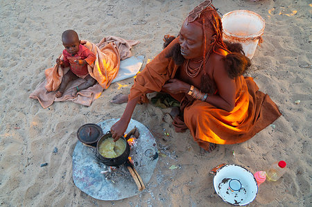 simsearch:841-03674817,k - One senior red ochred Himba woman with her child cooking on an open fire, Puros Village, nearr Sesfontein, Namibia, Africa Stock Photo - Rights-Managed, Code: 841-09194466