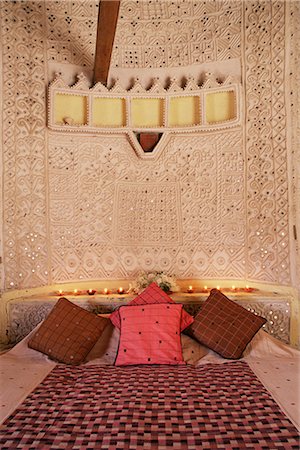Raised mud reliefs inlaid with mirror on the walls of bedroom in modern home in traditional tribal Rabari round mud hut, Bunga style, near Ahmedabad, Gujarat state, India, Asia Stock Photo - Rights-Managed, Code: 841-02704564