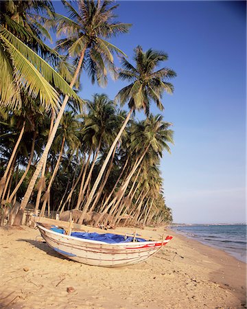 simsearch:841-03518373,k - Small boat on palm fringed beach, Mui Ne beach, south-central coast, Vietnam, Indochina, Southeast Asia, Asia Stock Photo - Rights-Managed, Code: 841-02705730