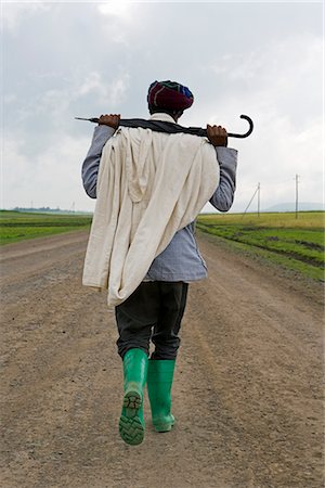 simsearch:841-02717553,k - Man walking along the road during the rainy season wearing green boots and holding an umbrella, The Ethiopian Highlands, Ethiopia, Africa Stock Photo - Rights-Managed, Code: 841-02705881