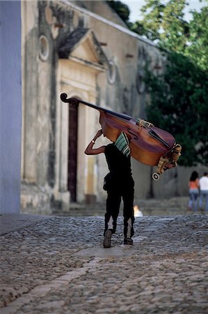 simsearch:841-03507904,k - Musician carrying double bass along cobbled street to Plaza Mayor, Trinidad, Cuba, West Indies, Central America Stock Photo - Rights-Managed, Code: 841-02707635