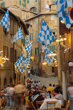 flag in front of house - Palio banquet for members of the Onda (Wave) contrada, Siena, Tuscany, Italy, Europe Stock Photo - Rights-Managed, Code: 841-02708714