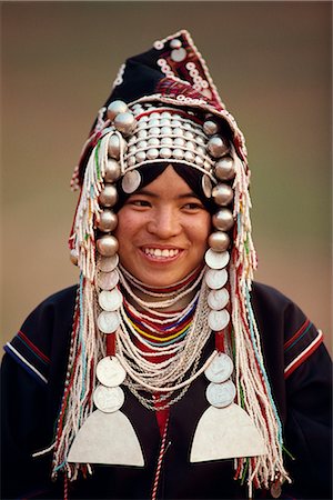 simsearch:841-02946091,k - Portrait of a smiling woman of the Akha hill tribe wearing head-dress of silver and coins, in the Golden Triangle, Thailand, Southeast Asia, Asia Stock Photo - Rights-Managed, Code: 841-02703997