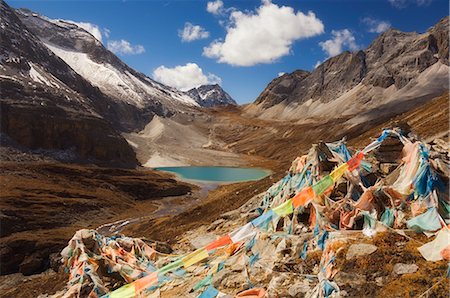 Prayer flags and Erongcuo Lake, Yading Nature Reserve, Sichuan Province, China, Asia Stock Photo - Rights-Managed, Code: 841-02719416