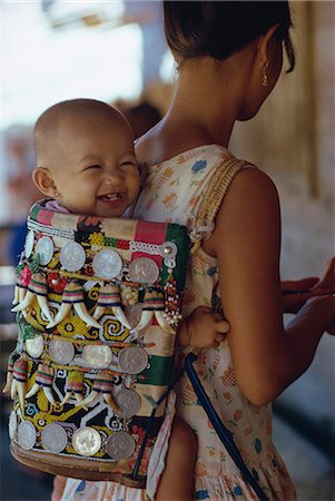 Kenyah woman with baby in a traditional carrier, Kalimantan, Borneo, Indonesia, Asia Stock Photo - Rights-Managed, Code: 841-02711483
