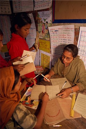 dhaka - A Bangladeshi woman teacher marks students books in a school in the slums of Dhaka (Dacca), Bangladesh, Asia Stock Photo - Rights-Managed, Code: 841-02712161