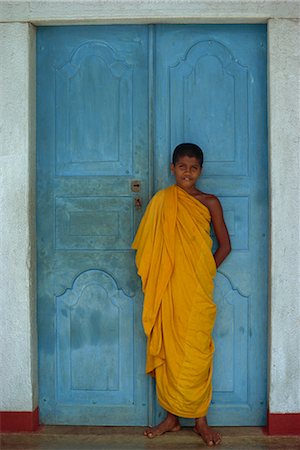 simsearch:841-02946644,k - Portrait of a young Buddhist monk in saffron robe in front of a blue door near Kandy, Sri Lanka, Asia Stock Photo - Rights-Managed, Code: 841-02713444