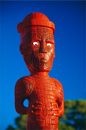 A carved figure, or poupou, in a Maori village at the Whakarewarewa thermal and cultural area of Rotorua, North Island, New Zealand Stock Photo - Rights-Managed, Code: 841-02722725
