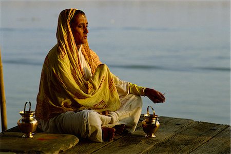 Woman meditating on the banks of the River Ganges, Varanasi, Uttar Pradesh state, India, Asia Stock Photo - Rights-Managed, Code: 841-02900287