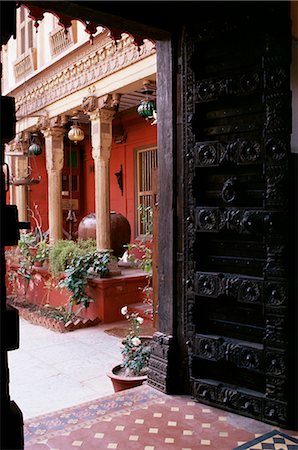 Traditional wood door and 19th century floor tiles in restored traditional Pol house, Ahmedabad, Gujarat state, India, Asia Stock Photo - Rights-Managed, Code: 841-02900607