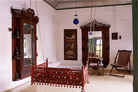 Seating area with traditional hitchkar suspended swing seat in restored traditional Pol house, Ahmedabad, Gujarat state, India, Asia Stock Photo - Rights-Managed, Code: 841-02900614
