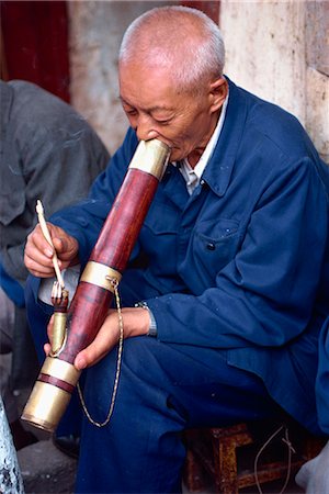 Portrait of a man smoking a long pipe at a tea house in Kunming, China, Asia Stock Photo - Rights-Managed, Code: 841-02901172