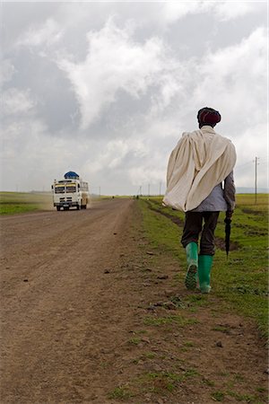 simsearch:841-02717553,k - Man walking along the road during the rainy season wearing green boots and holding an umbrella, The Ethiopian Highlands, Ethiopia, Africa Stock Photo - Rights-Managed, Code: 841-02903077