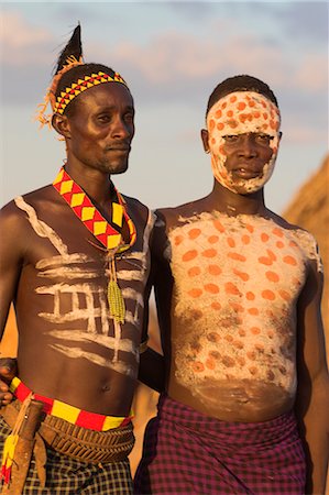 Karo men with body painting, made from mixing animal pigments with clay, at dancing performance, Kolcho village, Lower Omo valley, Ethiopia, Africa Stock Photo - Rights-Managed, Code: 841-02916979