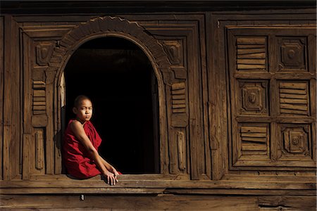 simsearch:841-02946644,k - Novice monk sitting in window of 18th century wooden monastery of Nat Taung Kyaung (May-taung taik) thought to be the oldest wooden monastery in the area, Bagan (Pagan), Myanmar (Burma), Asia Stock Photo - Rights-Managed, Code: 841-02917150