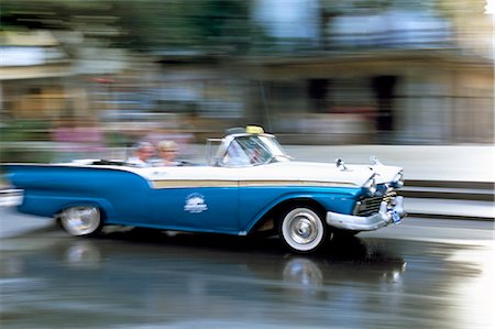 simsearch:841-03507904,k - Panned shot of old American car splashing through puddle on Prado, Havana, Cuba, West Indies, Central America Stock Photo - Rights-Managed, Code: 841-02918001