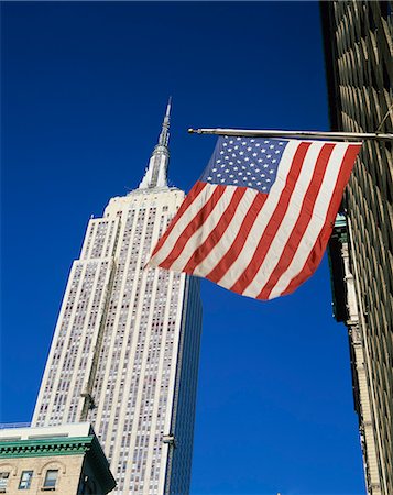 empire state building - The American flag, the stars and stripes in front of the Empire State Building in New York, United States of America, North America Stock Photo - Rights-Managed, Code: 841-02918470