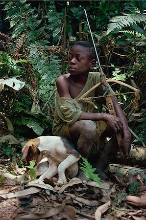 simsearch:841-02946644,k - Young boy sitting in jungle with dog and wooden crossbow, southeast area, Cameroon, West Africa, Africa Stock Photo - Rights-Managed, Code: 841-02918800
