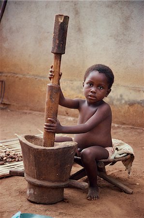 Portrait of young boy playing with pestle and mortar, Congo, Africa Stock Photo - Rights-Managed, Code: 841-02918811