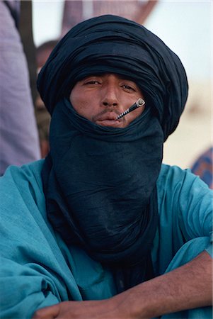 Young Tuareg man smoking small pipe and wearing headscarf, Timbuktu, Mali, West Africa, Africa Stock Photo - Rights-Managed, Code: 841-02918812