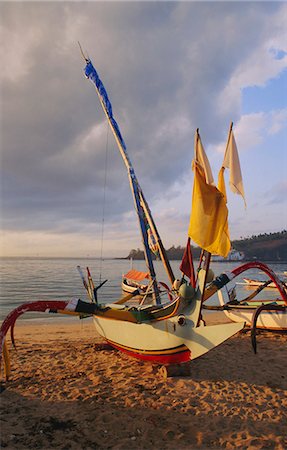 simsearch:841-02946821,k - Traditional outrigger boats drawn up on the beach in the early evening, Bali, Indonesia, Asia Stock Photo - Rights-Managed, Code: 841-02925619