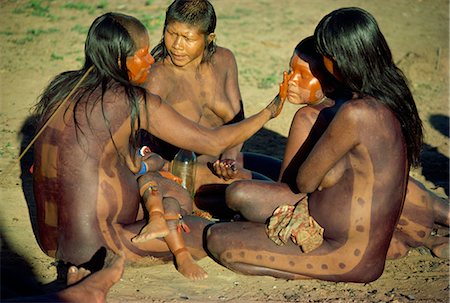 A group of Xingu women applying body paint in Brazil, South America Stock Photo - Rights-Managed, Code: 841-02945420