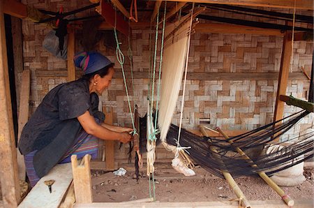 simsearch:841-02946091,k - Side view of a Hmong woman indoors weaving on a loom, Laos, Indochina, Southeast Asia, Asia Stock Photo - Rights-Managed, Code: 841-02947124
