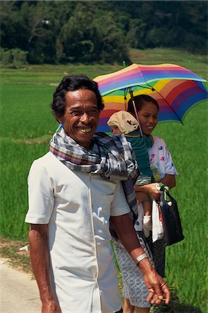 simsearch:841-02925433,k - Portrait of a family, mother, father and baby, walking through a rice field, the man smiling and looking at the camera, Toraja area, Sulawesi, Indonesia, Southeast Asia, Asia Stock Photo - Rights-Managed, Code: 841-02991300