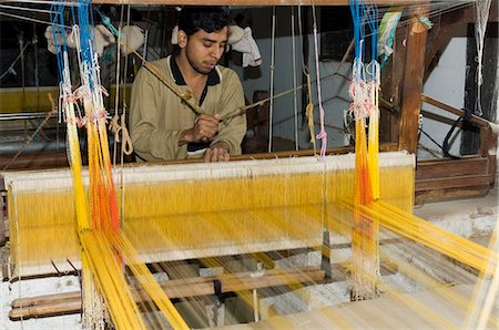 A man weaving at one of the cooperatives in an area that is famous for its saris, Maheshwar, Madhya Pradesh state, India, Asia Stock Photo - Rights-Managed, Code: 841-02992328