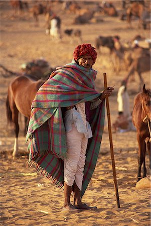pushkar - Portrait of an Indian farmer in traditional clothing, wearing turban and shawl, standing and looking at the camera, at Pushkar Camel Fair, Pushkar, Rajasthan, India, Asia Stock Photo - Rights-Managed, Code: 841-03030422