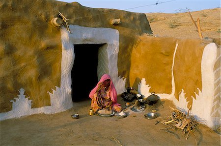 Woman cooking outside house with painted walls, village near Jaisalmer, Rajasthan state, India, Asia Stock Photo - Rights-Managed, Code: 841-03032800