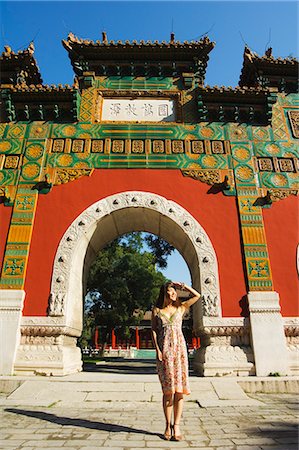east asia places - Chinese girl under a glazed archway at the Confucius Temple Imperial College, built in 1306 by the grandson of Kublai Khan, administering the official Confucian examination system, Beijing, China, Asia Stock Photo - Rights-Managed, Code: 841-03055654