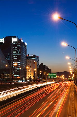 Car light trails and modern architecture on a city ring road, Beijing, China, Asia Stock Photo - Rights-Managed, Code: 841-03055749