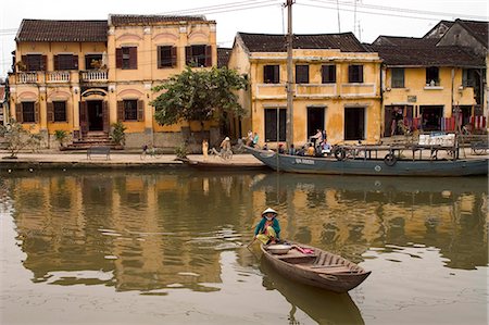 simsearch:841-02705251,k - Boat on river in front of yellow coloured colonial buildings, Hoi An, Vietnam, Southeast Asia, Asia Stock Photo - Rights-Managed, Code: 841-03056685