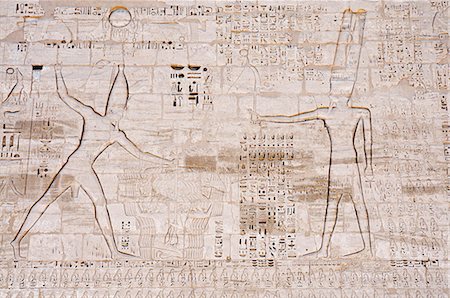 simsearch:841-03032736,k - Giant relief of Rameses III smiting enemies before Amen-Ra, South Tower of the first Pylon, Madinat Habu Temple, West Bank, Thebes, UNESCO World Heritage Site, Egypt, North Africa, Africa Stock Photo - Rights-Managed, Code: 841-03062469