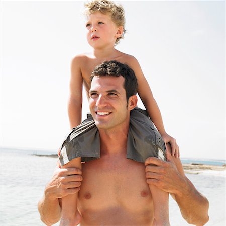 friends piggyback beach - Son (6-8) sitting on father's shoulders on beach Stock Photo - Rights-Managed, Code: 841-03507740