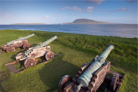 Skansin fort, old fort guarding Torshavn and its harbour, with old brass cannons, Second World War British marine guns and lighthouse, Nolsoy in the distance, Torshavn, Streymoy, Faroe Islands (Faroes), Denmark, Europe Stock Photo - Rights-Managed, Code: 841-03507817