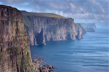 faroe islands - High cliffs between 200 and 300m high, on west coast of Sandoy, Svartskorardrangur and Oknadalsdrangur sea stacks, Sandoy, Faroe Islands (Faroes), Denmark, Europe Stock Photo - Rights-Managed, Code: 841-03507811